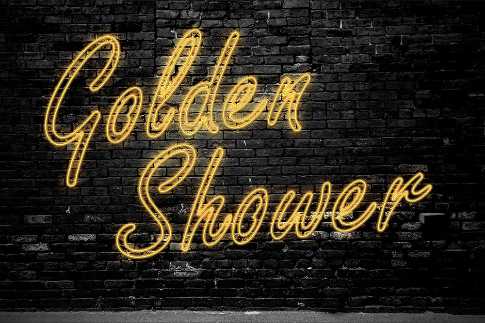 Schwarze Ziegelmauer mit gelbem Leuchtschriftzug Golden Shower