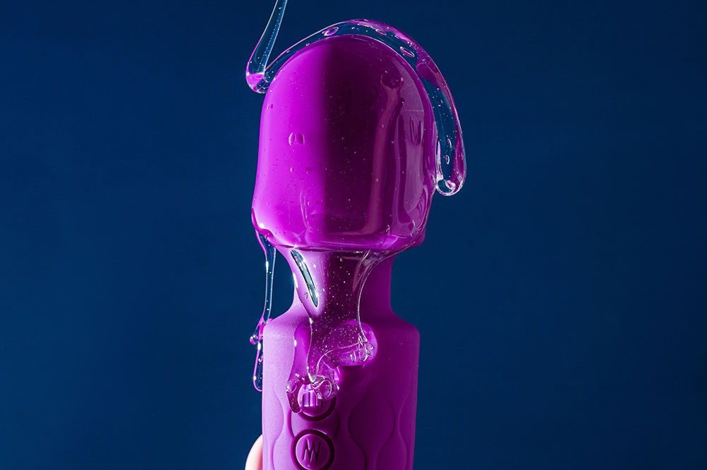 Dunkelrosa Vibrations-Sextoy mit viel Gleitgel übergossen